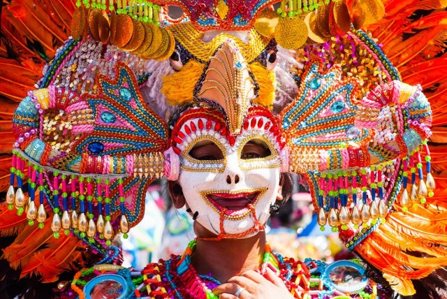 36176846 - masskara festival performer wearing bird mask